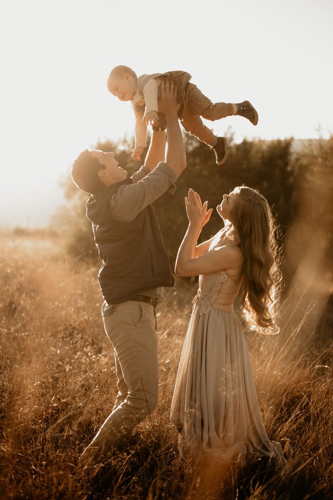 Dad playing with his son in a field at The Nut Farm