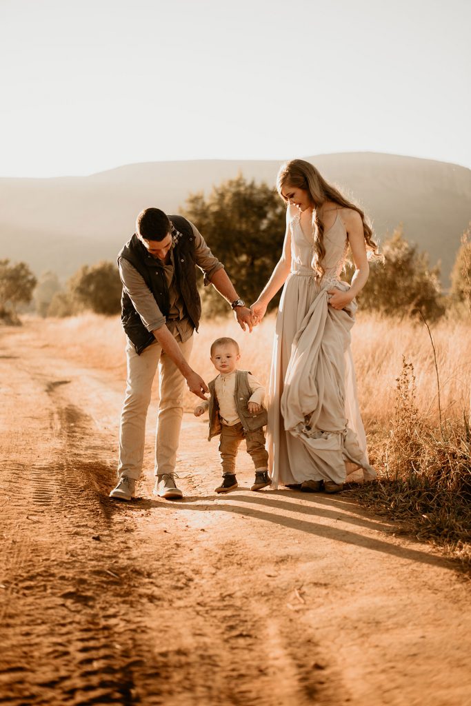 Family walking down a dirt road