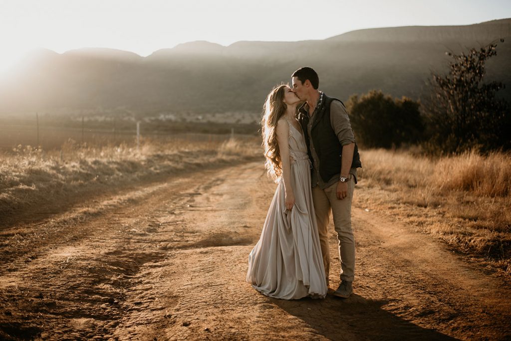 Kissing in a field The Nut Farm Venue by Echo Photography