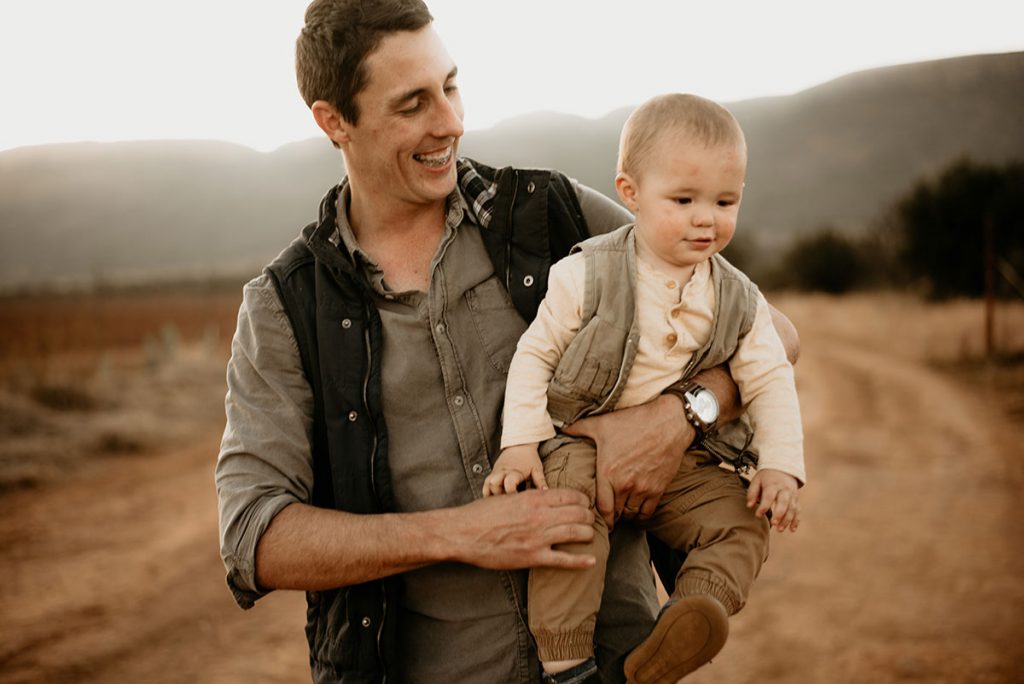 Dad paying with his son at The Nut Farm Venue by Echo Photography