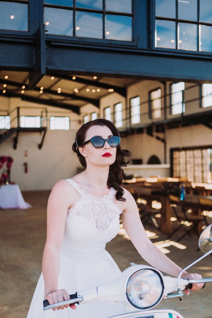 Bride arriving at wedding in The Nut Farm in Vespa